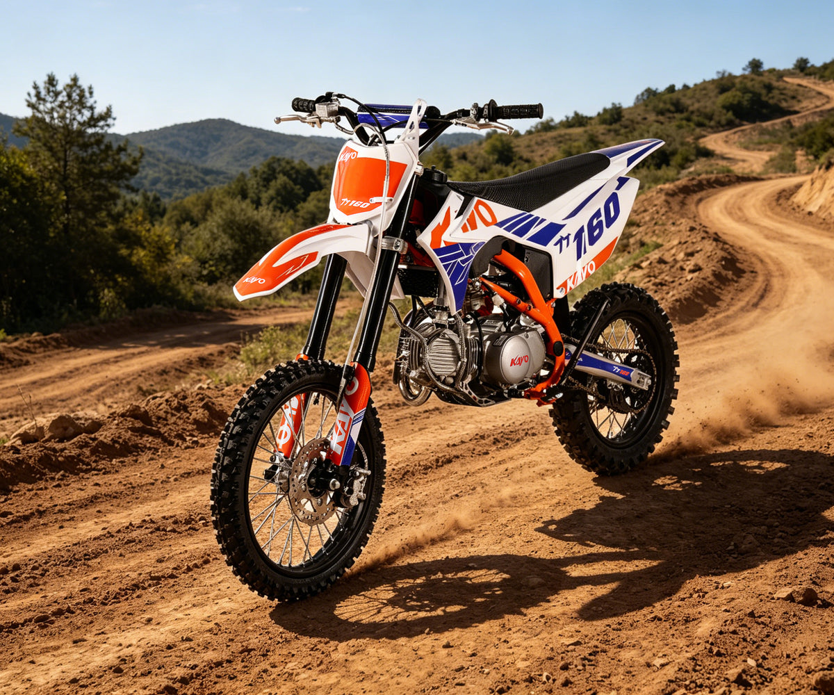 KAYO TT160 rider on mountain dirt trail overlooking scenery