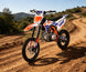 KAYO TT160 rider on mountain dirt trail overlooking scenery