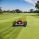 SAAQ101 remote-controlled lawn mower working on a golf-course fairway in a square composition